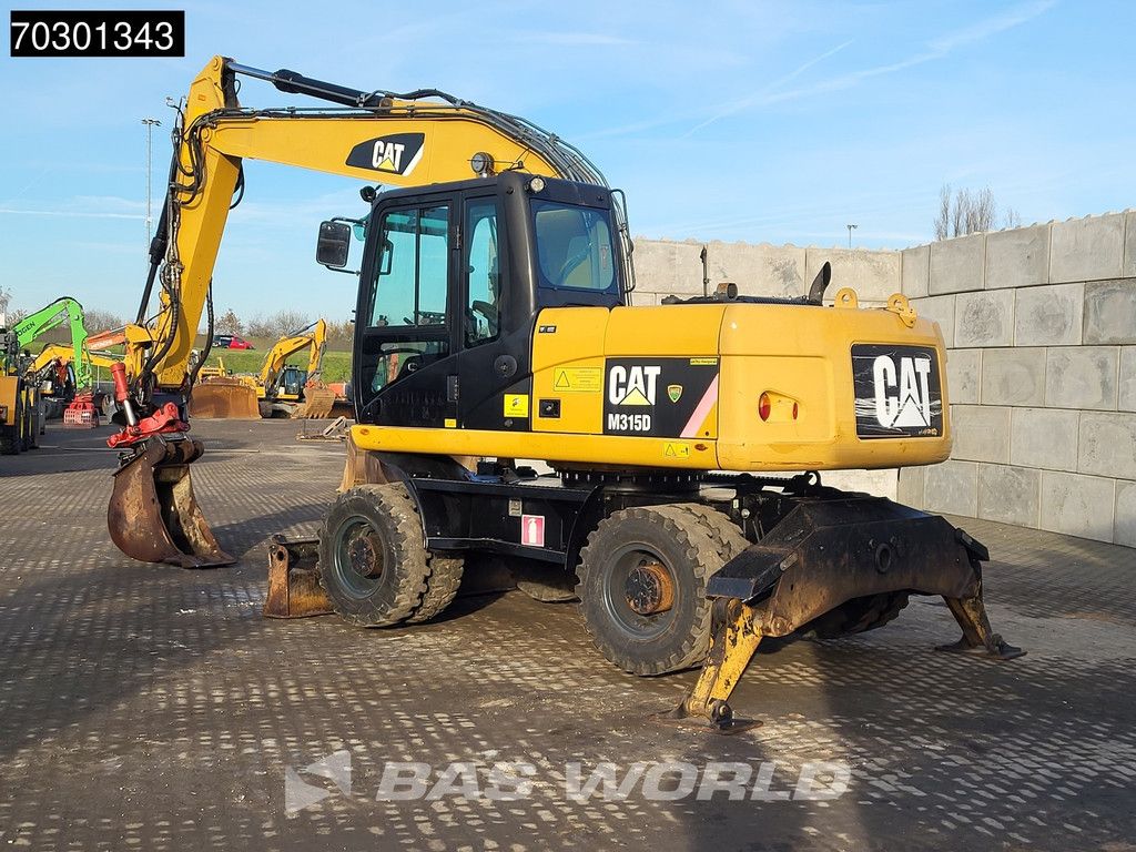 Caterpillar M315 D OUTRIGGERS + BLADE